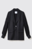 Giacca in twill monopetto con maniche a sbuffo a contrasto e polisino • Nero