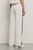 Pantalone palazzo con bande su fianchi e stampa • Bianco