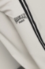 Pantalone palazzo con bande su fianchi e stampa • Bianco