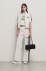 Pantalone palazzo con bande su fianchi e stampa • Bianco