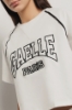 T shirt crop paricollo raglan con inserti profilo • Bianco