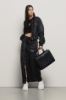 Bomber nylon cropped zippato con smacchinato su polsi e stampa • Nero