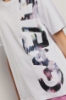 T shirt jersey paricollo con maxi stampa • Bianco