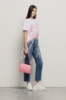 T-shirt lunga girocollo con fondo laserato a frange e stampato • Bianco