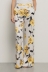 Pantalone a palazzo in raso stampato • Rose gialle