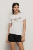 T-shirt paricollo con appl. brick oro/argento • Bianco