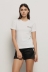 T-shirt paricollo in bielastico con logo oro lato cuore • Bianco