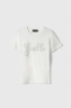 Immagine di T-Shirt Paricollo Mezza Manica Con Logo Ricamato E Appl. Strass E Borchie • Off White